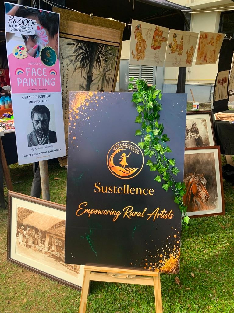 Sustellence stall sign promoting face painting and live portraits at the Ladies College Retro Riot Carnival.